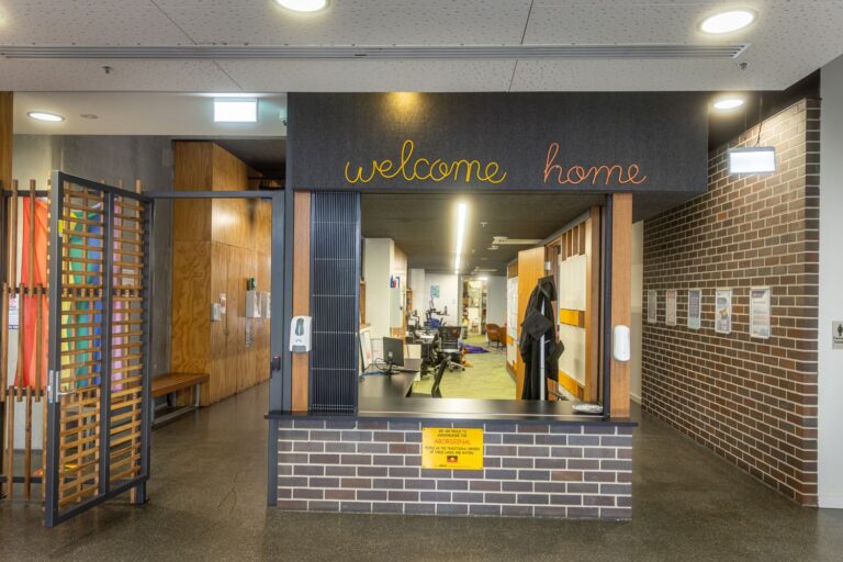 Photo of the entry to the Broadmeadows Education First Youth Foyer, with a sign in cursive that reads "Welcome Home".