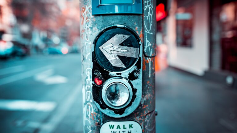 Close up photo of a button at a pedestrian crossing in Melbourne.